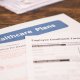 A desk with papers related to healthcare plans and employee enrollment forms.